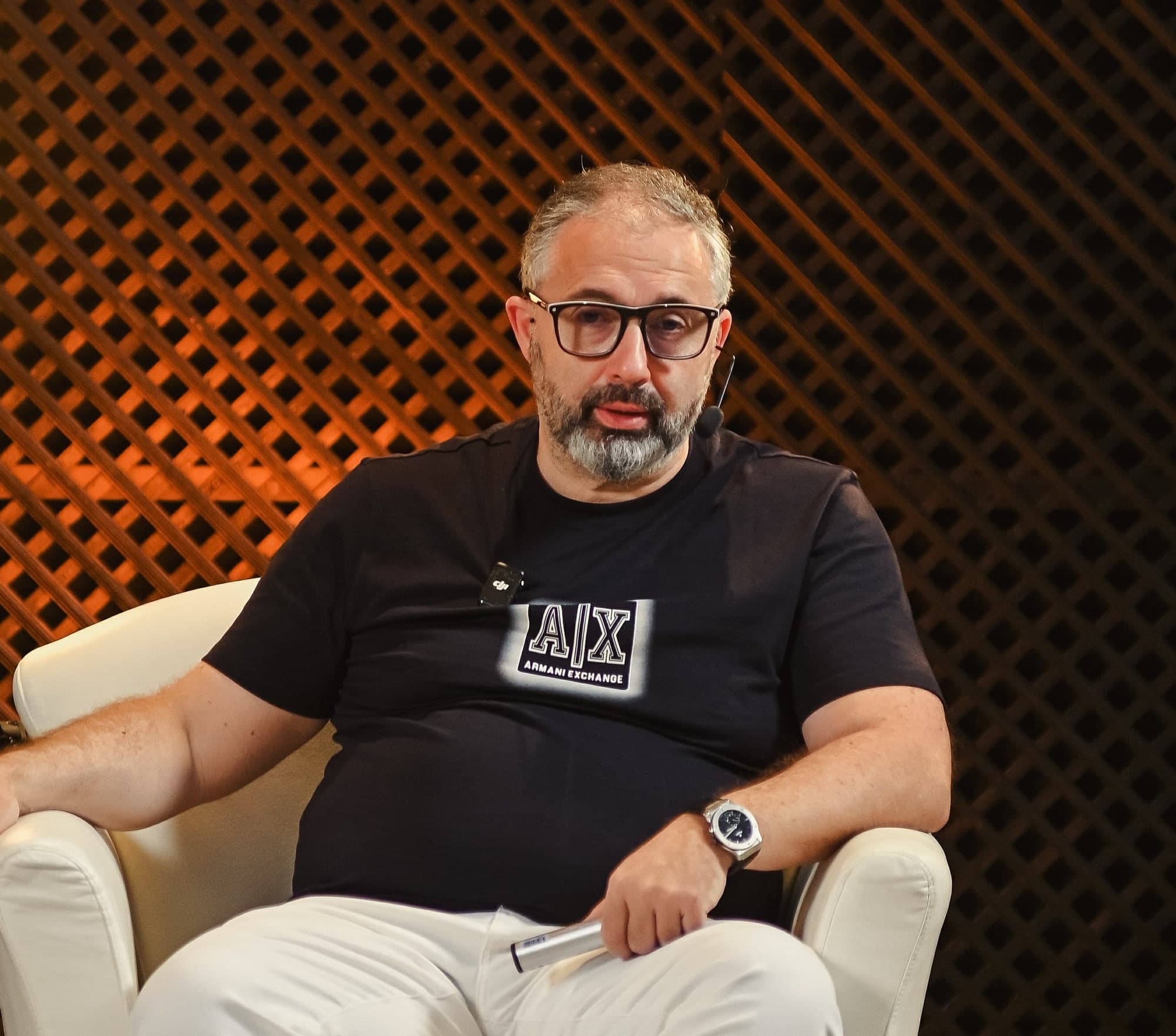 Alex Yanovsky seated, speaking at a live session
